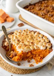 The Best Southern Sweet Potato Casserole Recipe 3 Paula Deen sweet potato casserole with golden marshmallow topping on a holiday table